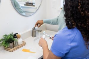 close up of sink and tooth brush getting ready to brush teeth