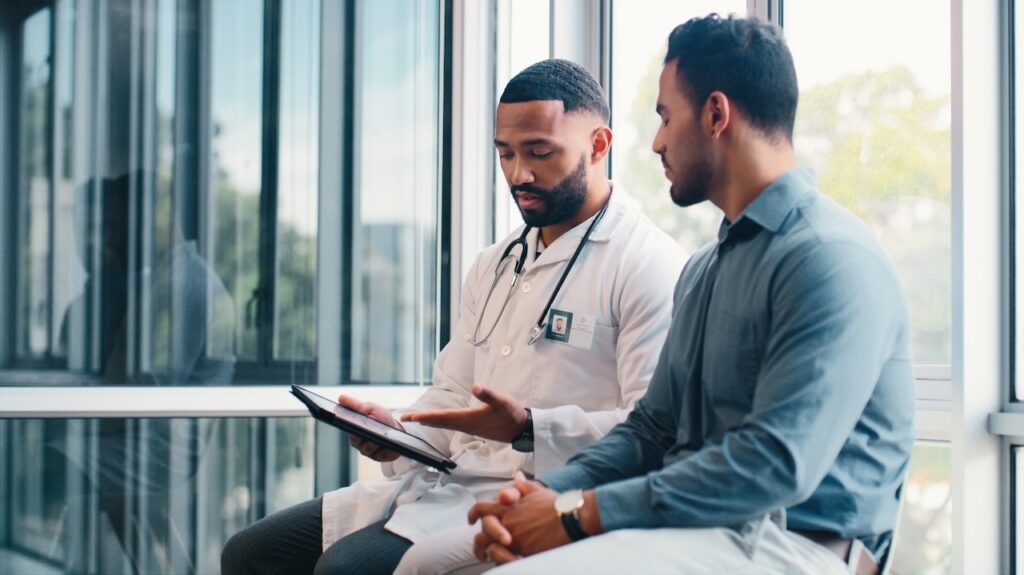 Doctor consultation with patient, tablet and hospita