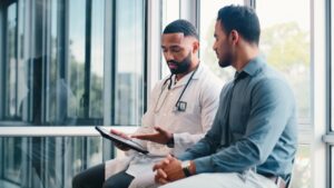Doctor consultation with patient, tablet and hospita