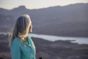 Portrait of senior female hiker on mountain summit