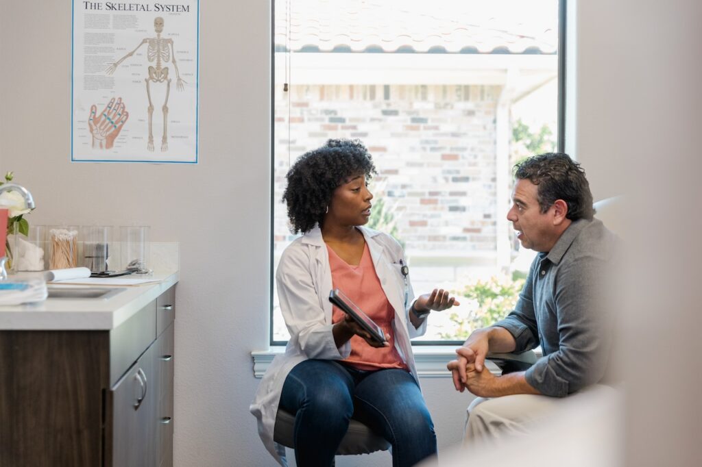 Doctor explains test results to male patient