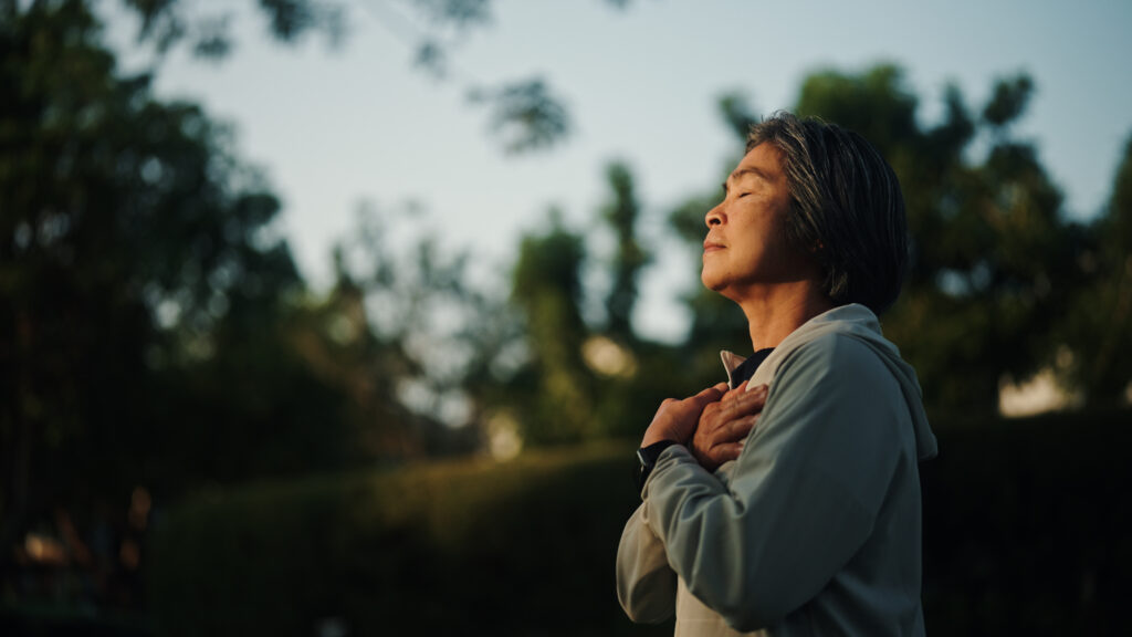 woman meditating in nature for wellness and relaxation