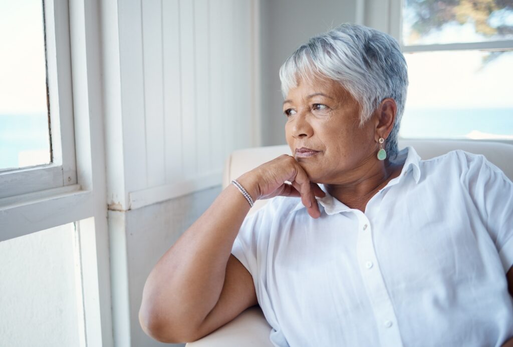 woman sitting in a chair looking out the window