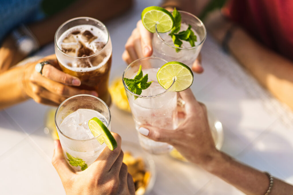 Group of people celebrating toasting with drinks