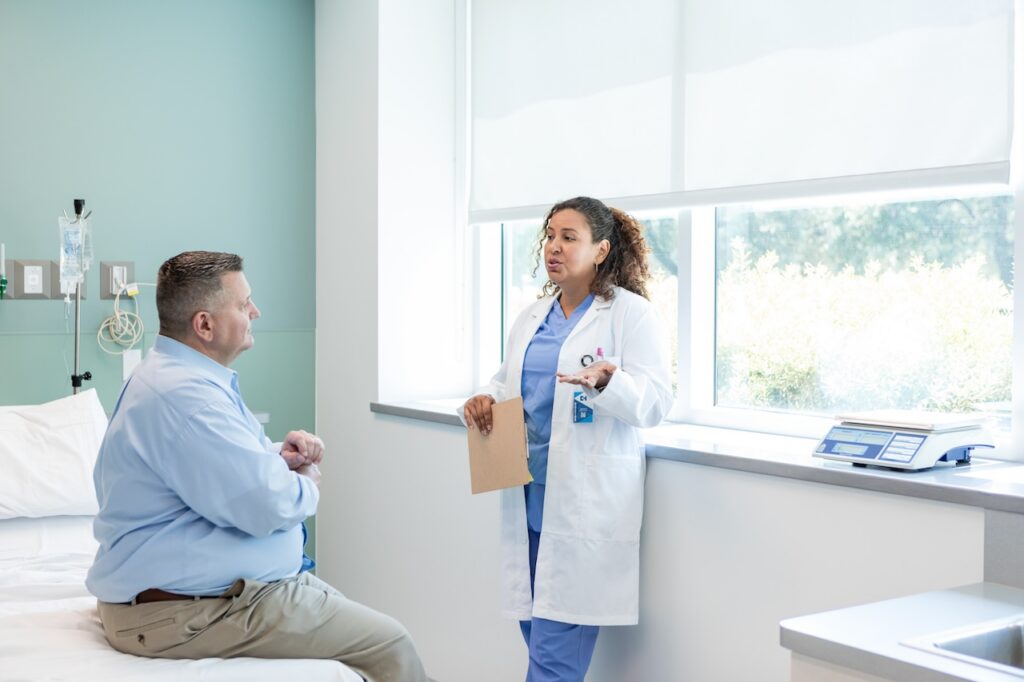 doctor talks to patient in clinic