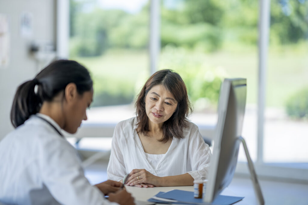 woman sitting down with her doctor at the office