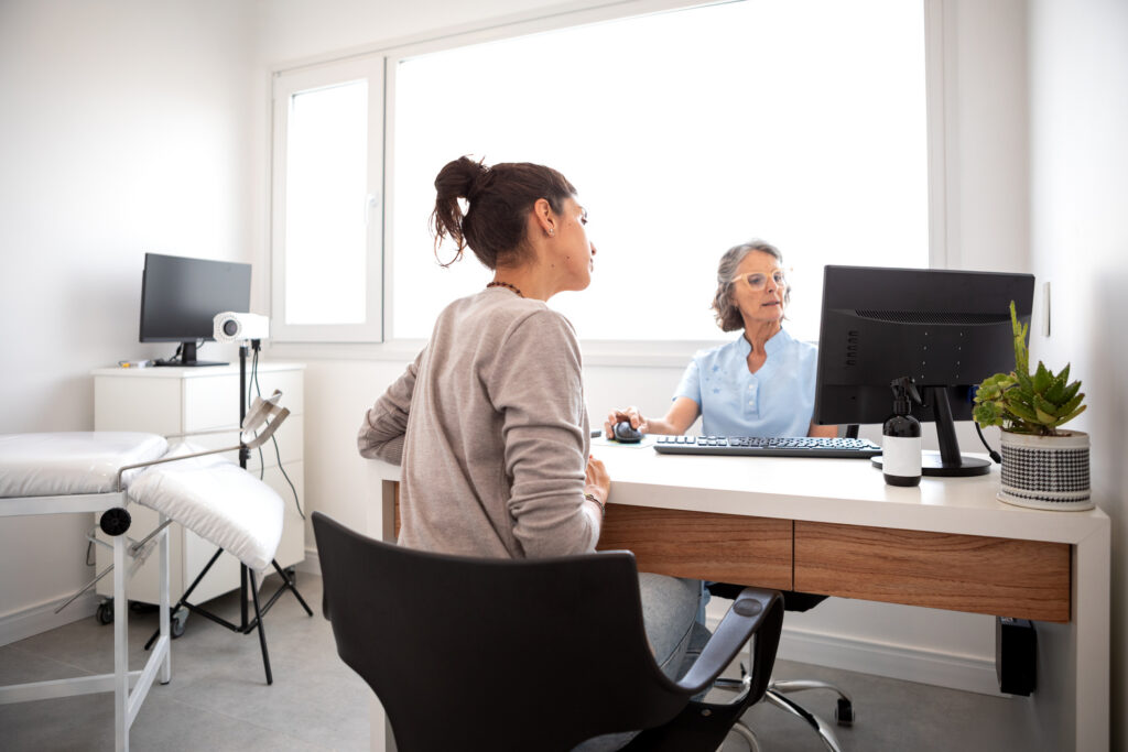 Female gynecologist in a consultation with her female patient analyzing medical exams