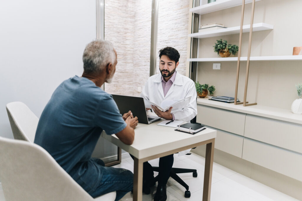 Doctor talking with his patient while read a medical document on a doctor's office