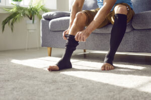 Man wears compression stockings
