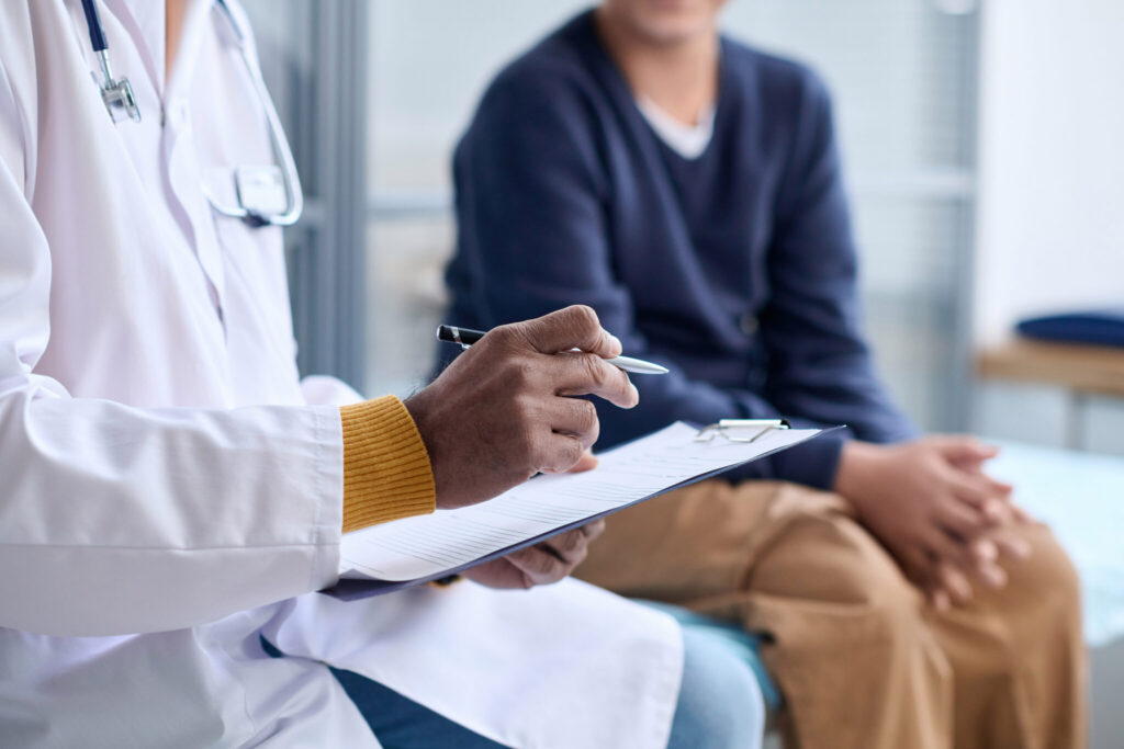 Doctor Holding Clipboard Consulting patient