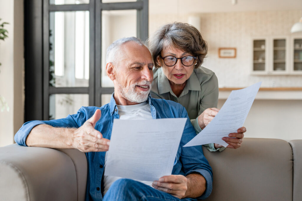 man and woman looking at a report together at home