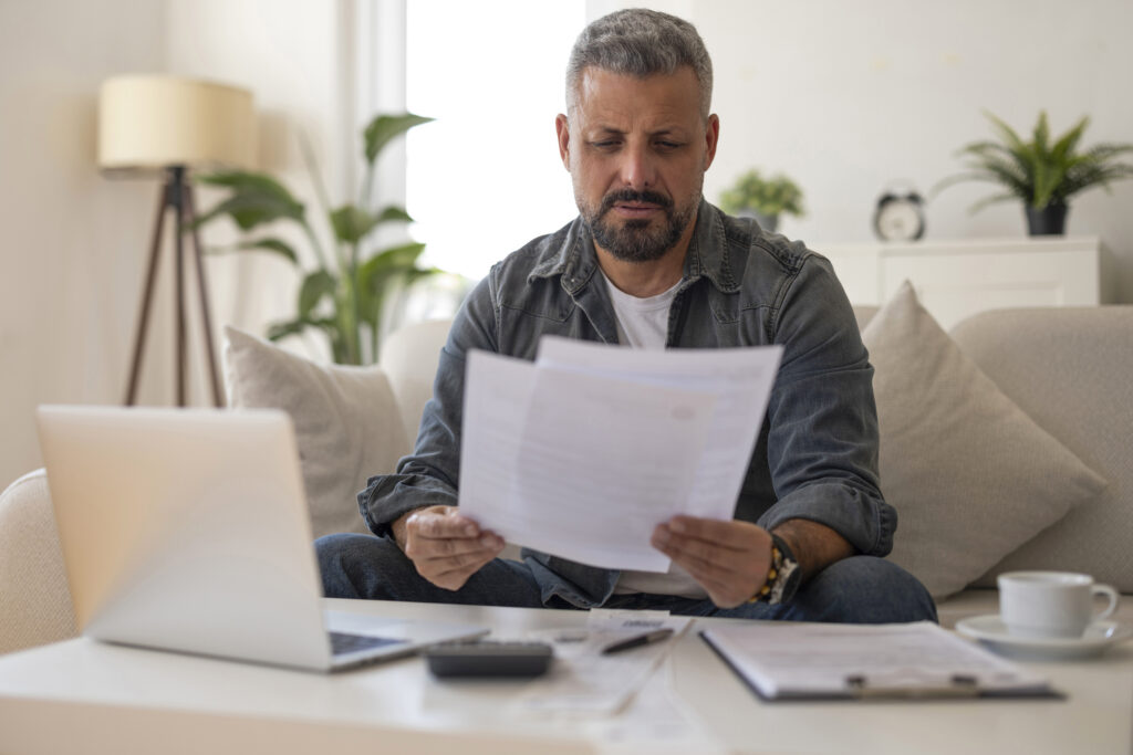 Man Reviewing Documents at Home Office